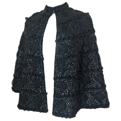 Bead and sequin embellished 1950s black wool capelet with interlaced ribbon